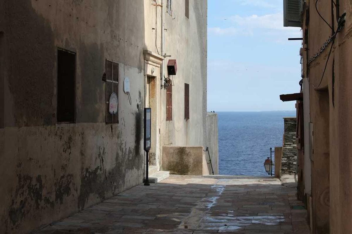 A smiling Moroccan host welcoming guests at their door